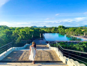 Woman walking near pool in Aliya Resort & Spa, hotel Sigiriya Dambulla
