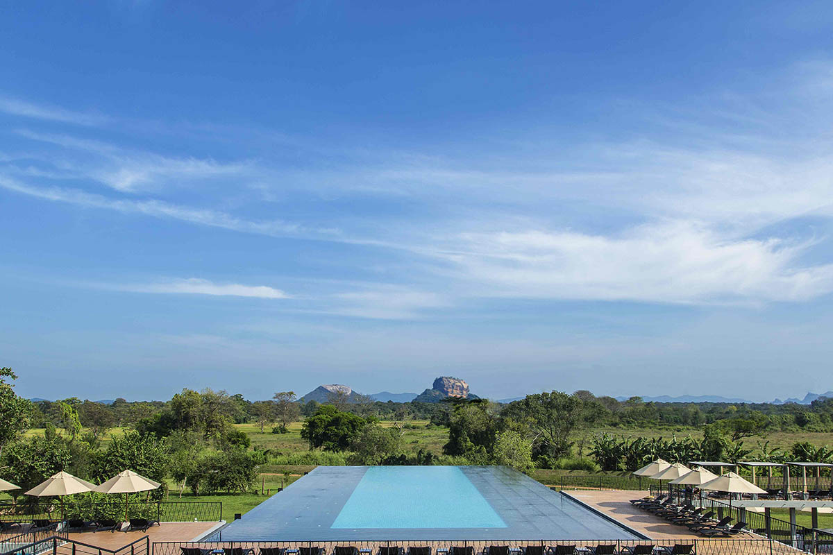 Poolside view of Sigiriya at Aliya Resort
