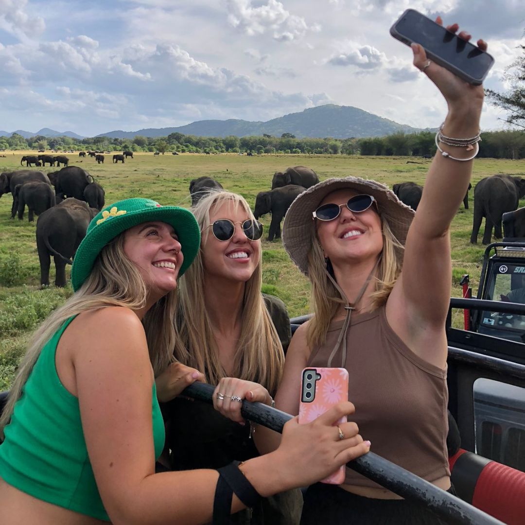 Tourists on safari taking a selfie with elephants in Sri Lanka
