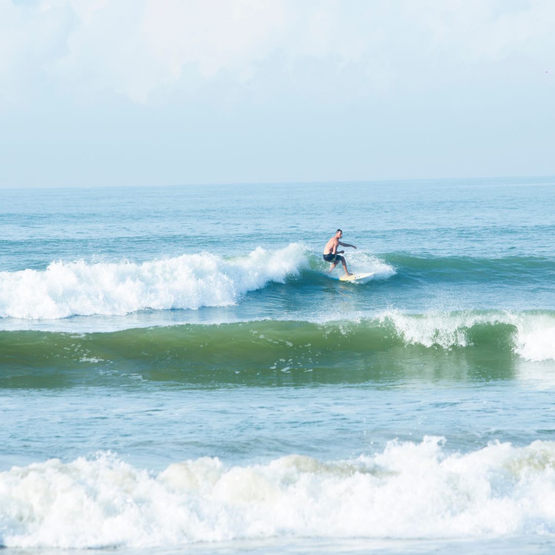 Surfer Riding Waves at Weligama Beach Near Parangi Weligama