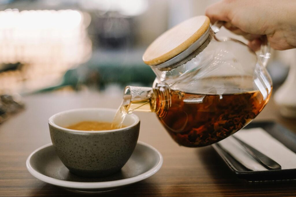 Freshly brewed Ceylon tea poured into a cup, showing its clear amber colour