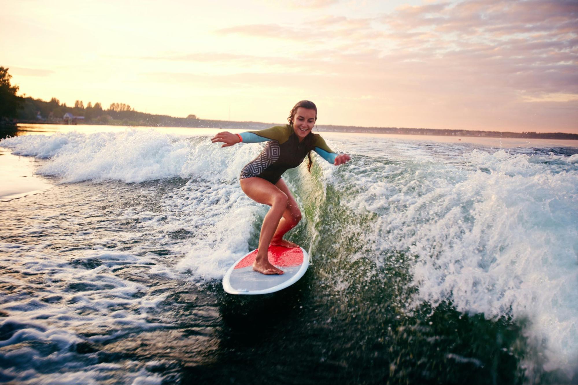 Beginner surfer riding a small wave in Weligama Bay, Sri Lanka