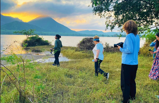 Visitors exploring the lakeside during sunset near Kandalama, one of the best locations for birdwatching near Sigiriya.