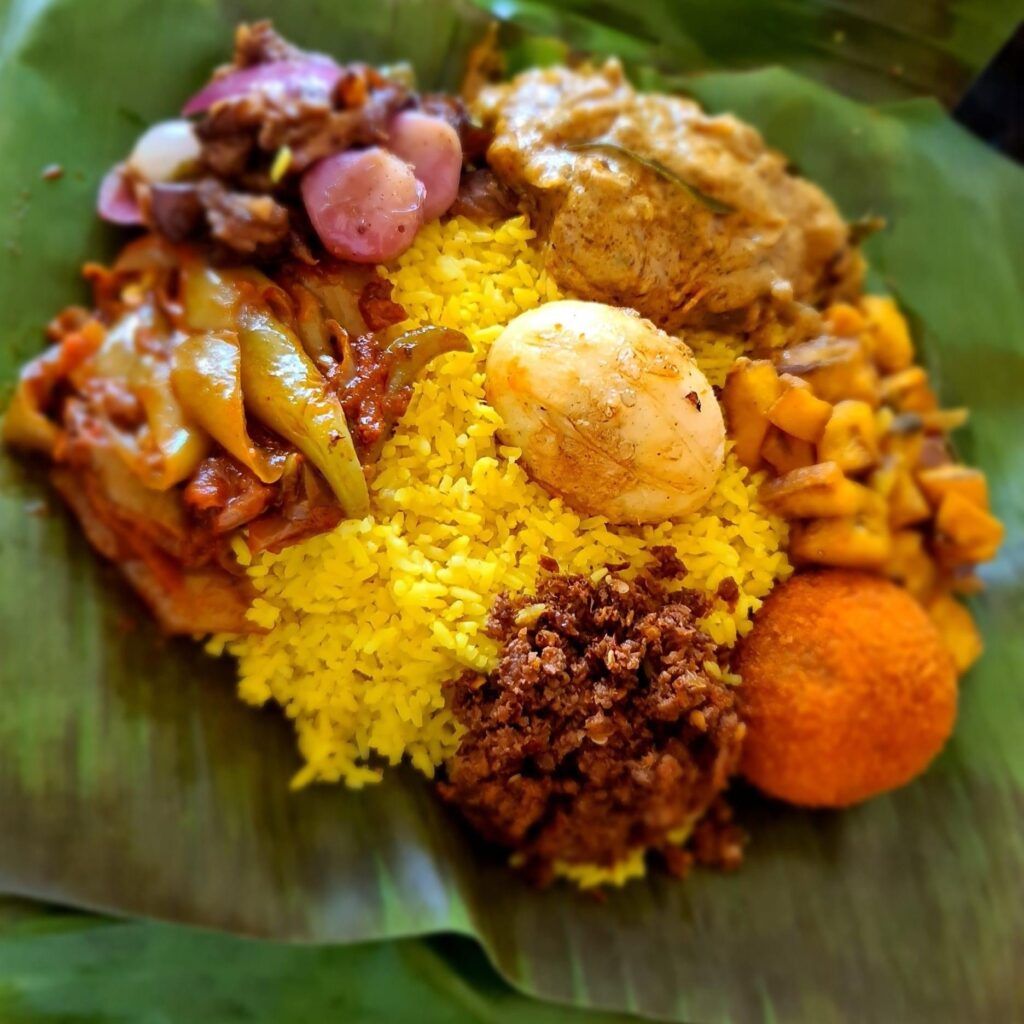 Lamprais, a Sri Lankan rice dish wrapped in a banana leaf with curry and sambol