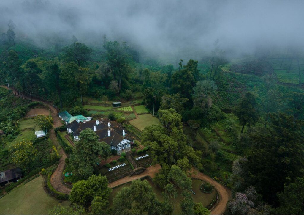Aerial view of Scottish Planter bungalow surrounded by tea estates and misty hills in Nuwara Eliya