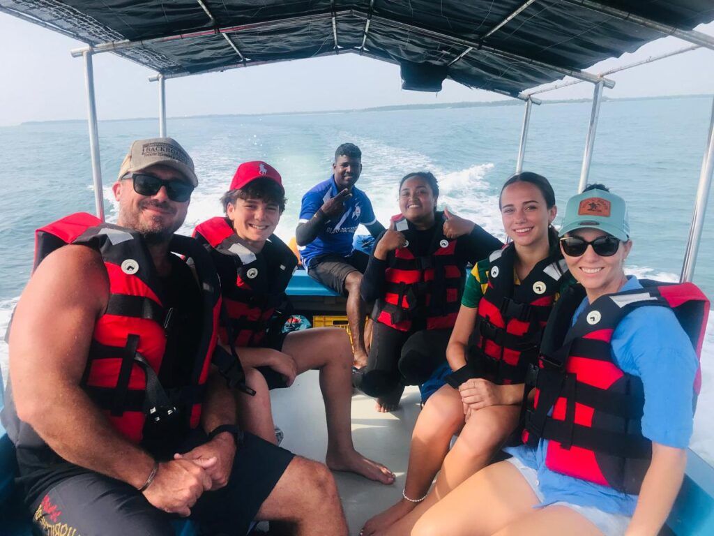 A team on a boat trip to go snorkelling in Pasikuda reef, Sri Lanka
