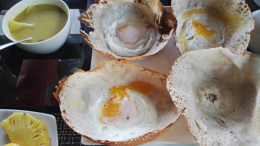 Egg hoppers, a Sri Lankan traditional breakfast dish with coconut milk and egg centre