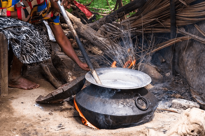 Milk being heated in a pot for traditional curd making