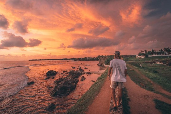 Traveller walking along the Galle Fort ramparts at sunset