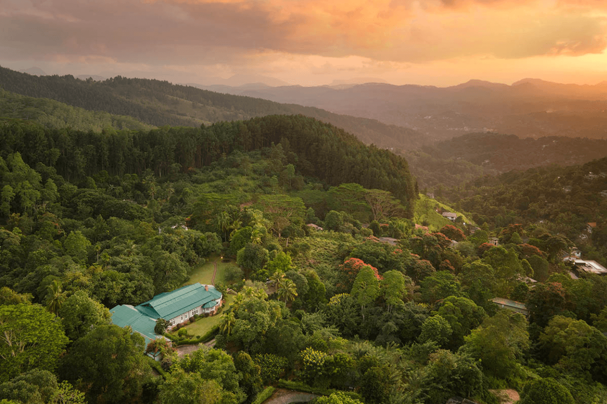 Mountbatten Bungalow exterior surrounded by hillside greenery.