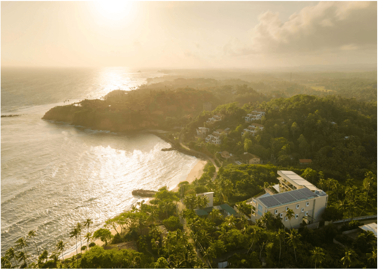 Aerial view of Ayurvie Weligama at sunset, looking out over Weligama Bay