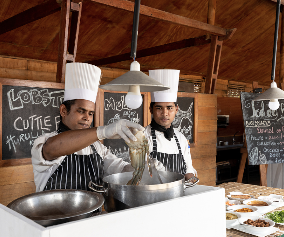 Chefs preparing the day's catch during the cooking demonstration at Maalu Maalu 