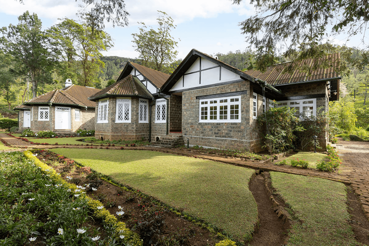 The garden and stone exterior of Scottish Planter Bungalow, a heritage bungalow in Nuwara Eliya.