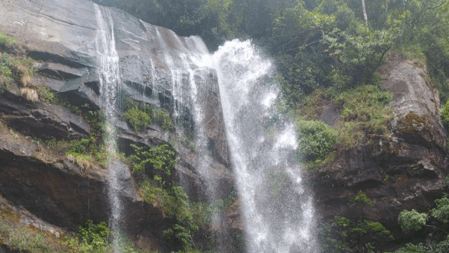 Pichchamala Ella waterfall flowing through the misty hills near Mandaramnuwara.