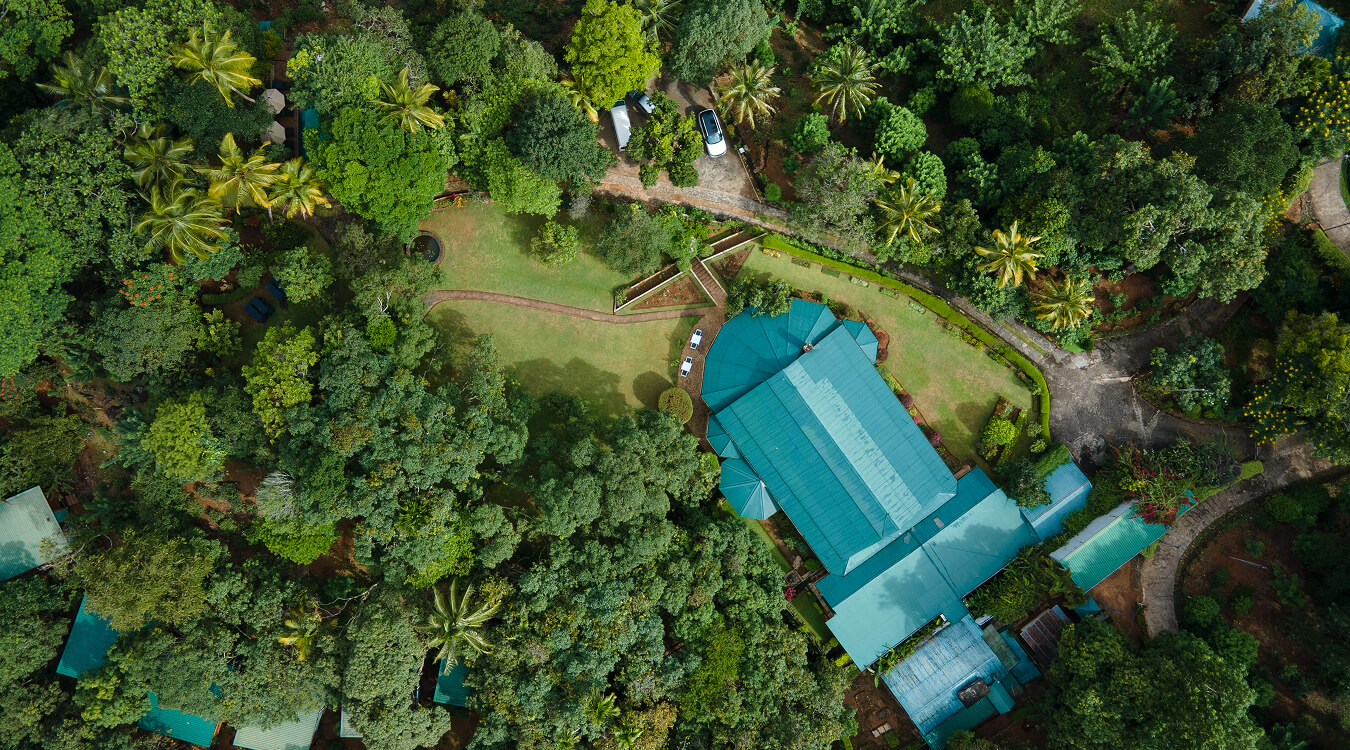 Aerial view of Mountbatten Bungalow showcasing lush surroundings and historic building preservation.